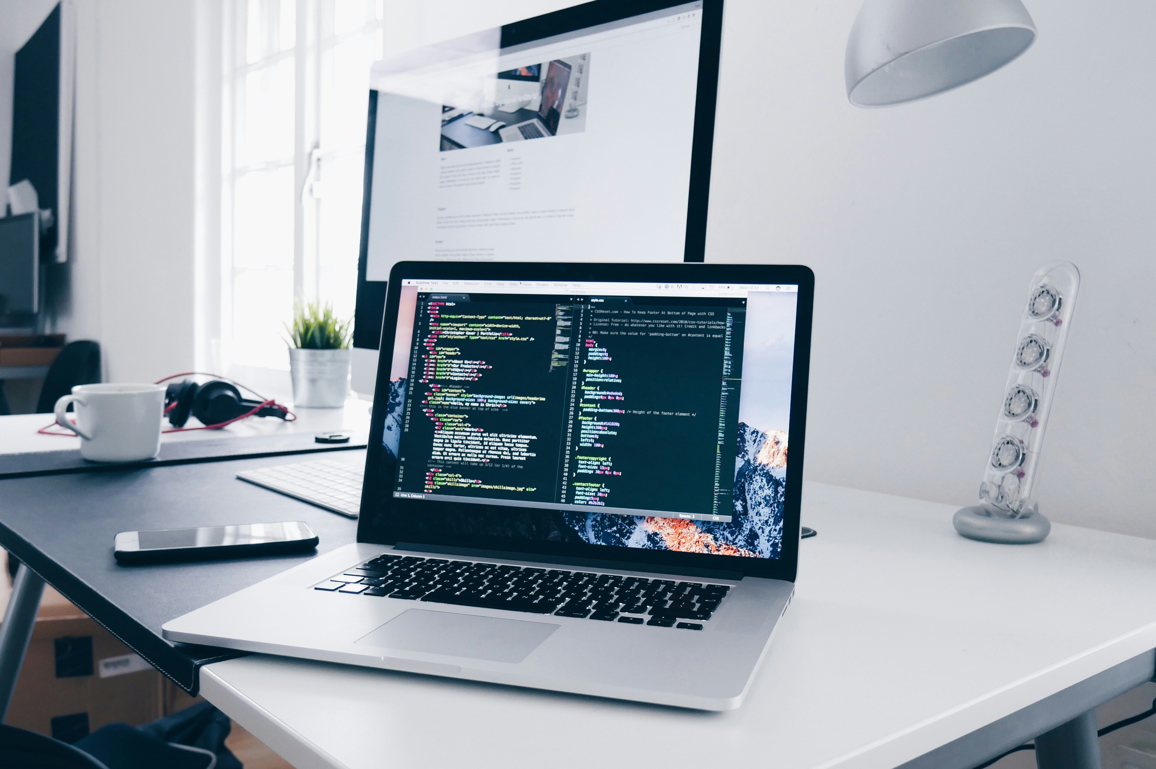 Laptop on a desk with code — adding a booking widget embed to an existing website