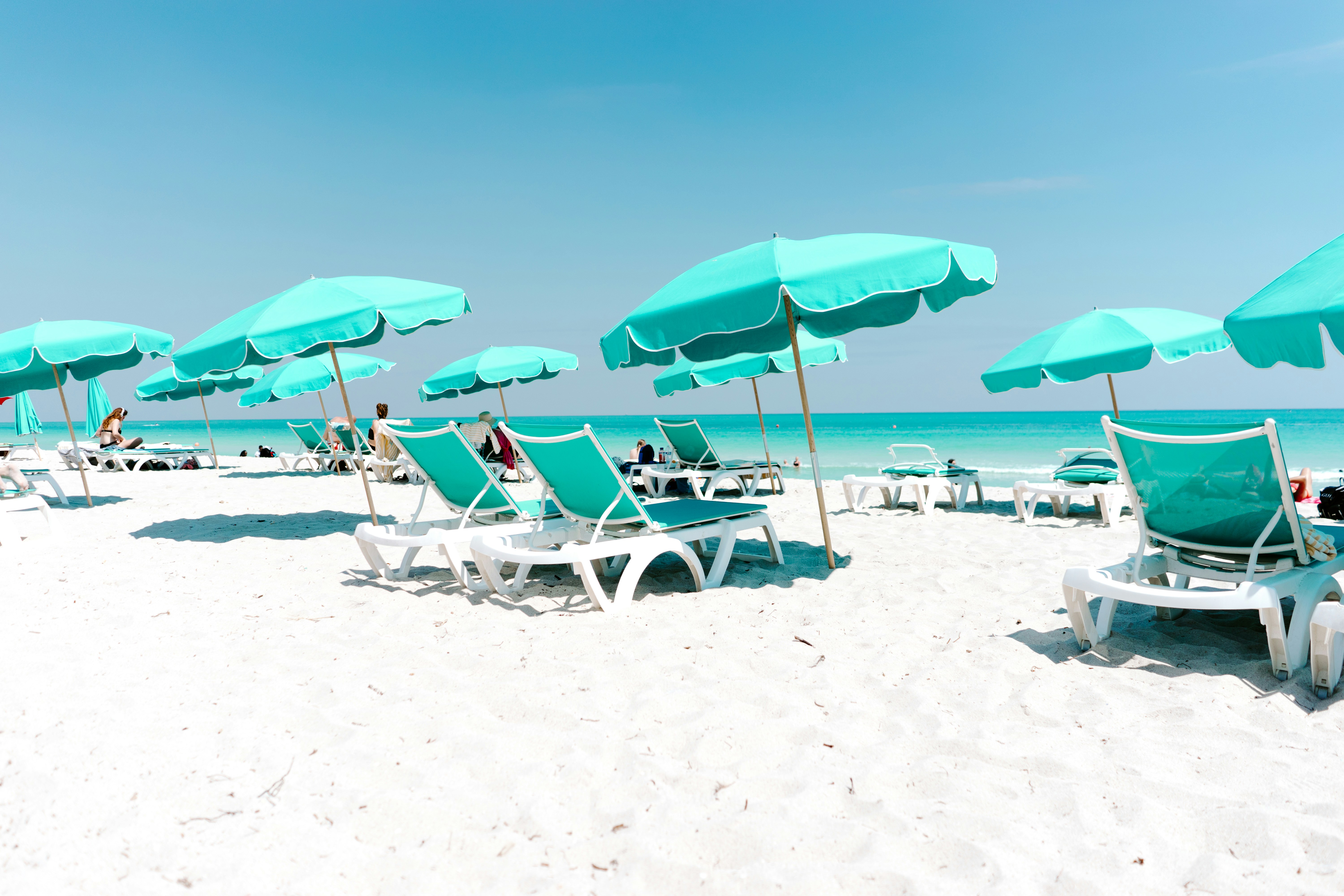 Beach lounge chairs under umbrellas — the travel mood hosts market on a direct booking brand