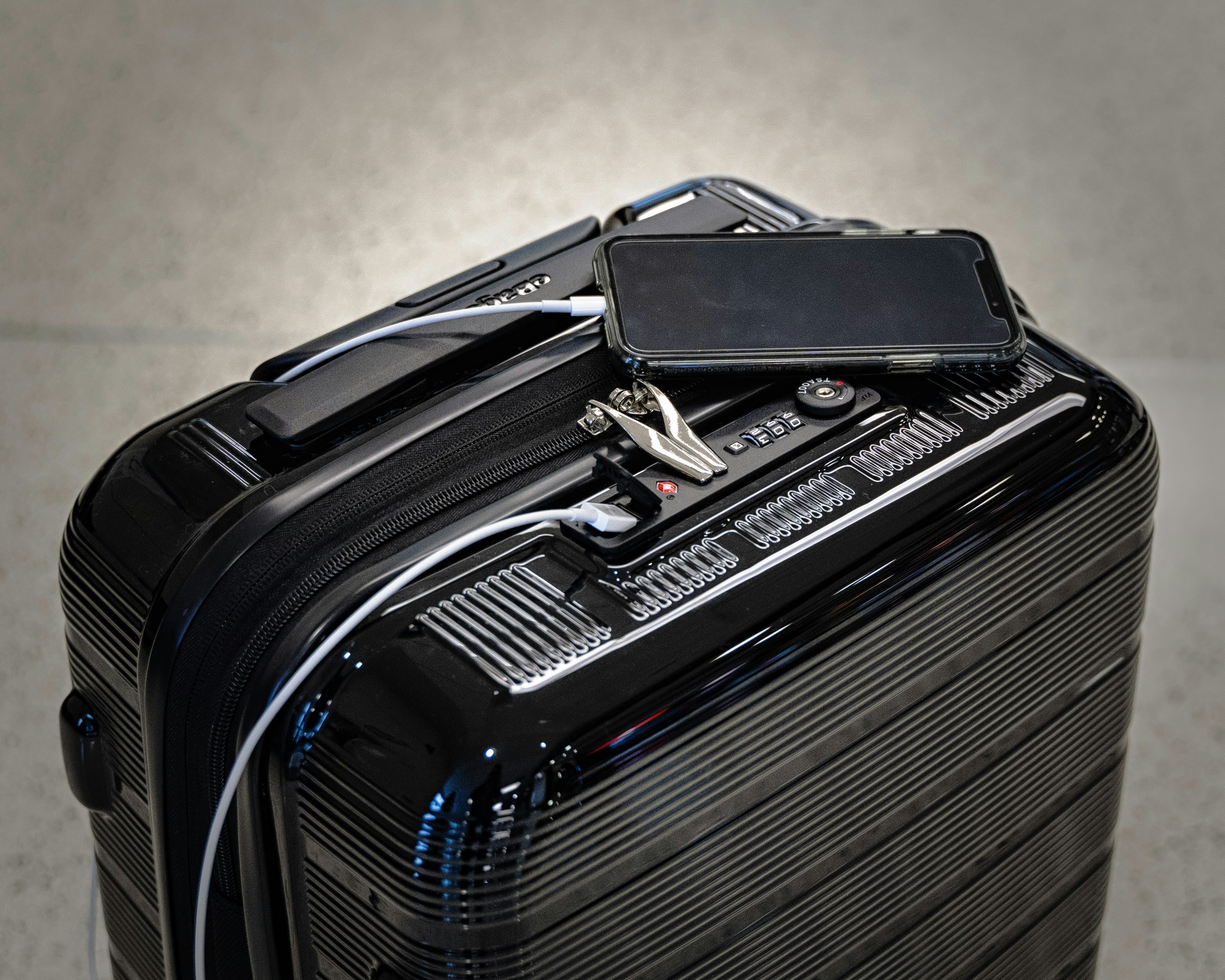 Carry-on suitcase with phone charging — extras guests may book as travel upsells